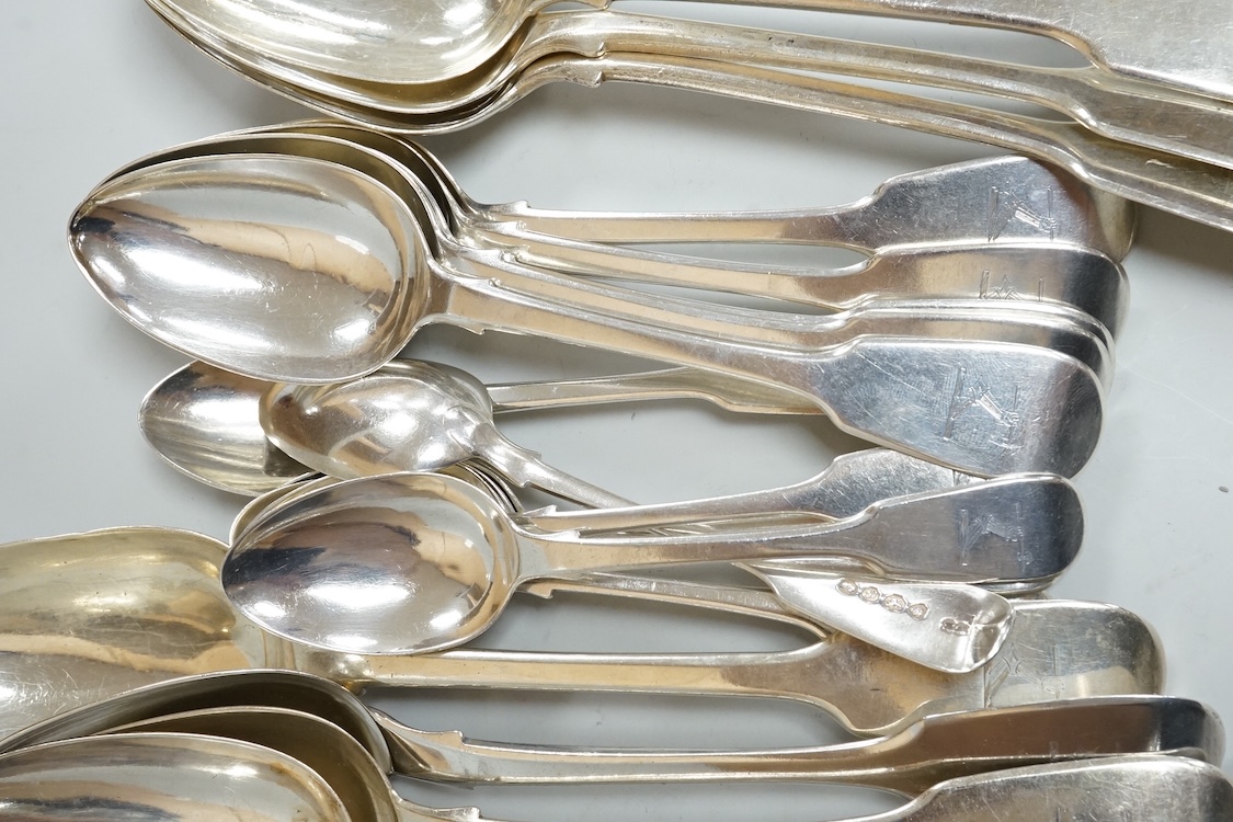 A harlequin part canteen of 19th century silver fiddle pattern flatware, comprising twenty six items, all with engraved crest various dates and makers, 32.3oz.